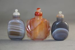 Two Chinese small banded agate snuff bottles, 5.8cm. with stoppers and a chalcedony snuff bottle