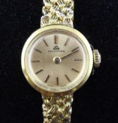 A lady`s 18ct gold Bucherer manual wind wrist watch, with baton numerals on an integral 18ct gold "