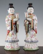 A pair of Chinese famille rose porcelain figures of ladies, 20th century, each standing and