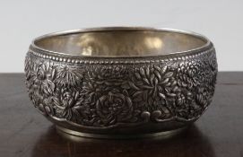 A Japanese silver double walled bowl, Meiji period, embossed and chased with varieties of