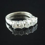 An 18ct white gold five stone diamond ring, with pierced setting, size M.