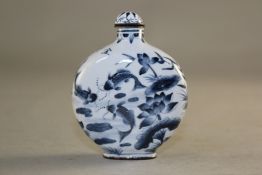 A Canton enamel snuff bottle, Qianlong mark but later, painted in dark blue tones with fish