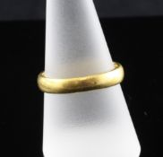 A 22ct gold wedding band, together with a gold signet ring with monogram, unmarked, size R, gross