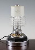 A Jaeger le Coultre combined table clock lamp, with later glass shade and chrome plinth, thought