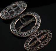 Two 19th century base metal and jargoon (zircon) belt buckles and a similar hair ornament, of oval
