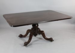 A William IV mahogany breakfast table, the rectangular top on a reduced base, on four scroll legs,