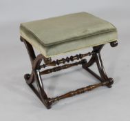 A Victorian rosewood `X` frame foot stool, with green padded seat, W.1ft 10in.