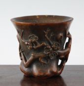 A Chinese bamboo libation cup, carved with openwork prunus branches, incised two character mark to