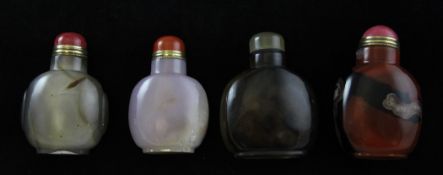 Four Chinese agate and chalcedony snuff bottles, one predominantly of brown and black tones, largest