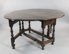 An 18th century oak gate leg dining table, on baluster supports and stretcher base, 4ft 2in.