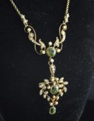 A late Victorian 15ct gold, peridot and split pearl set pendant necklace, of scrolling foliate