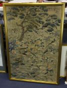 A Chinese embroidered silk panel, 19th century, of birds amid flowers and rockwork below a pine