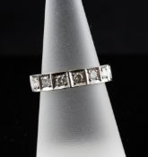 A late 1970`s 18ct white gold and diamond half eternity ring, set with seven stones, size N.