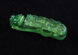 A Chinese translucent green glass belt hook, Republic period, carved with an openwork chi-dragon,