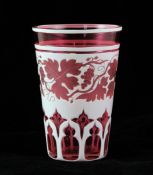 A Bohemian ruby and white overlaid glass beaker, late 19th century, wheel engraved with a band of
