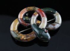 An Edwardian Scottish silver and hardstone pendant brooch, modelled as a serpent, with ruby glass
