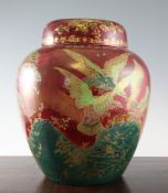 A large Crown Devon Fielding lustre ovoid jar and cover, decorated with eagles in a landscape, on
