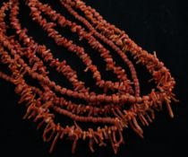 Four coral necklaces, with gilt metal clasps, of varying sizes with ovoid or jagged shaped beads,