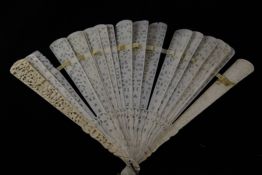 A large Chinese export ivory brise fan, late 19th century, the guards carved in high relief with