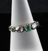 A mid 18th century gold and five stone collet set emerald and diamond ring, with pierced shank, size