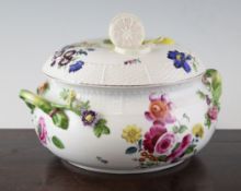 A German porcelain tureen and cover, late 19th century, painted with flower bouquets, the cover with