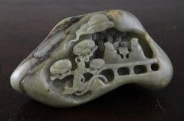 A Chinese celadon and russet jade boulder carving, carved in relief with two scholars playing
