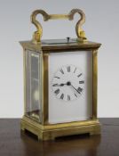 An Edwardian brass hour repeating carriage clock, with enamelled Roman dial, 5.75in.