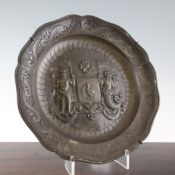 A 19th century pewter circular wall plate, with scallop edge and embossed to the centre with the