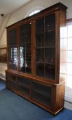 A large 19th century mahogany boxwood strung library bookcase, with three glazed doors over three