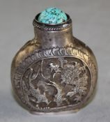 A Chinese white metal snuff bottle, embossed and chased with two birds amid flowers, the other