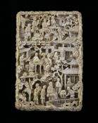 A Chinese export ivory card case, 19th century, carved in high relief with figures amid pavilions
