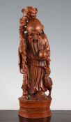 A Chinese boxwood standing figure of Shou Lao, holding his gnarled staff, a peach in his left hand