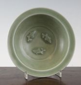 A Chinese celadon glazed `fish` dish, probably 19th century, the centre moulded in relief with three