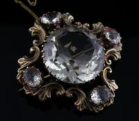 A Victorian gold and quartz set brooch, with large central stone and four smaller in scroll setting,