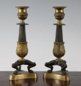 A small pair of late 19th century French Empire style candlesticks, with stiff leaf decoration, on