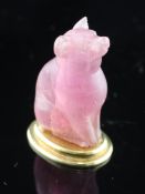 An Edwardian carved pink tourmaline mounted gold seal with matrix, modelled as a seated bear, in
