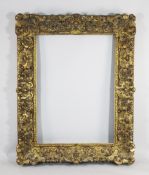 A large early 19th century carved giltwood and gesso picture frame, with a continuous border of