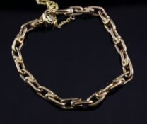 A modern gold chain link bracelet, with safety chain, unmarked, 32.8 grams.
