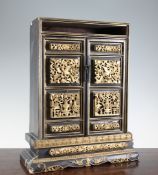 A Chinese black lacquer and gilt table cabinet, late 19th century, with a pair of panelled doors