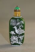 A Chinese overlaid snuff bottle, Qianlong seal mark but later, with white glass overlay of a duck