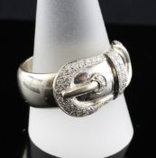 A modern 18ct white gold and diamond set buckle ring, stamped 750, gross 18.9 grams, size Y.