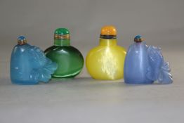 Four Chinese stained tigers eye quartz snuff bottles, of blue tone carved in relief with