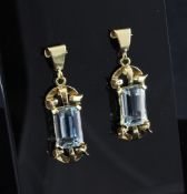 A pair of 18ct gold and aquamarine drop earrings, with emerald cut stones set in open scroll gold