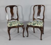 A pair of 18th century beech and fruitwood dining chairs, with shaped splats and serpentine drop