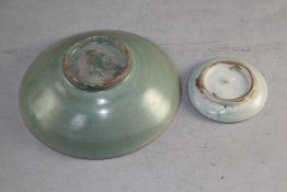 A Chinese Yingqing circular ink dish, Song Dynasty, 3.5in. and a Chinese celadon glazed shallow bowl