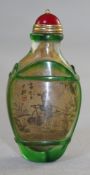 A Chinese inside painted and overlaid glass snuff bottle, painted with farmers in landscapes,