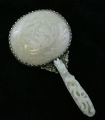 A Chinese white jade mounted hand mirror, with 18th century white jade belt hook handle, carved with