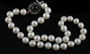 A South Sea Island cultured pearl choker necklace with diamond and almandine garnet set oval