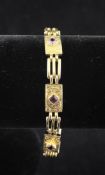 An Edwardian 9ct gold and amethyst set engraved panel and gate link bracelet, with heart shaped