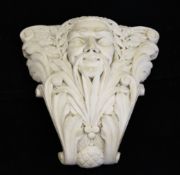 A Victorian carved marble corbel, decorated with a face showing through foliage, 11in.